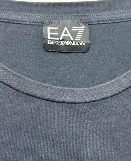 A close-up of an EA7 Emporio Armani collar and logo tag.